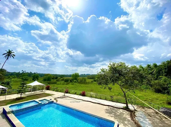 The swimming pool and Jacuzzi at Chandor Club, looking out over the fields